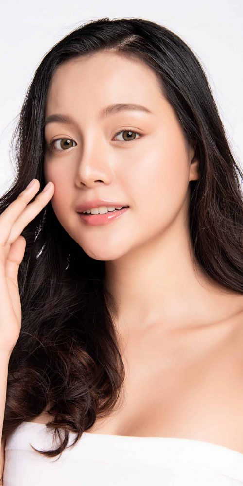 Beautiful Young asian Woman touching her clean face with fresh Healthy Skin, isolated on white background, Beauty Cosmetics and Facial treatment Concept,